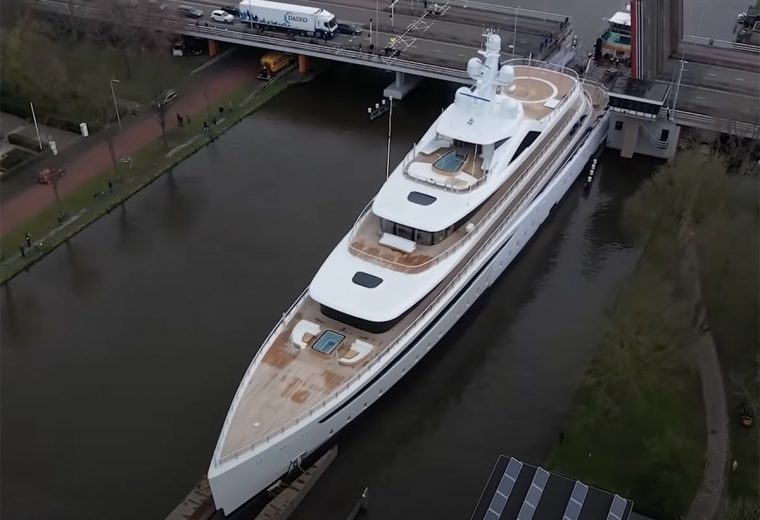 Superyacht towed through narrow canal in Netherlands