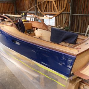 View from stern with Shipwright Gordon McGill, working on the instrument panel with Mitch Bray fitting the front deck hatch