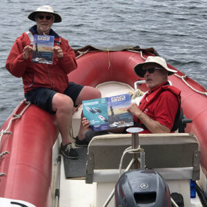 Volunteers catching up with the latest boating news while waiting for the fleet to arrive. Photo by Peter Webb