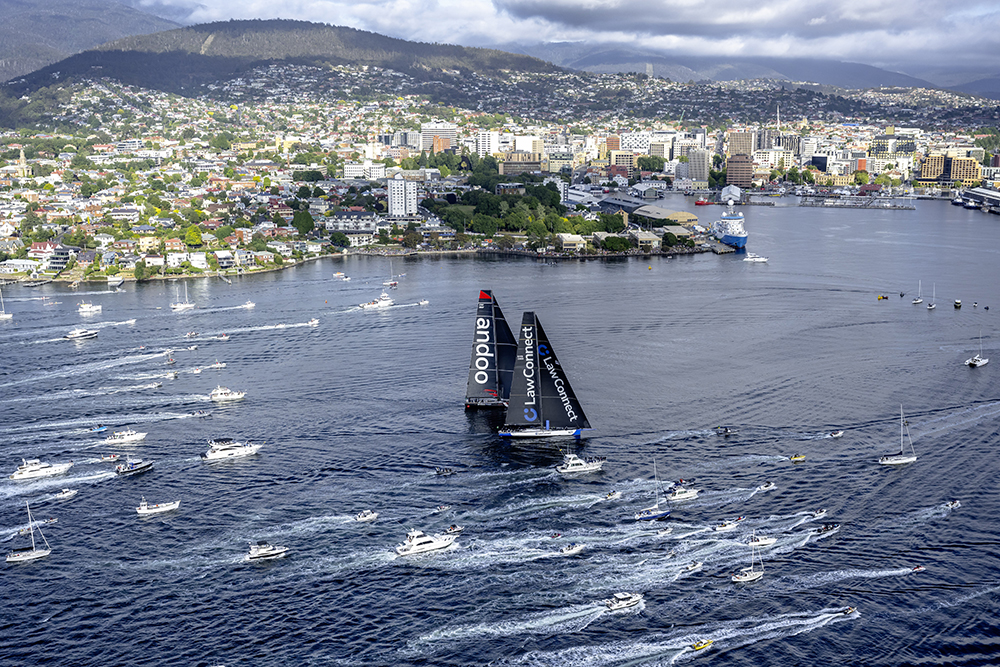 100-FOOT MAXI YACHTS LAWCONNECT AND ANDOO COMANCHE WERE NECK AND NECK ON THE FINISH LINE OF THE 78TH ROLEX SYDNEY HOBART YACHT RACE, PROVIDING A SPECTACULAR CONCLUSION TO THE BATTLE FOR LINE HONOURS