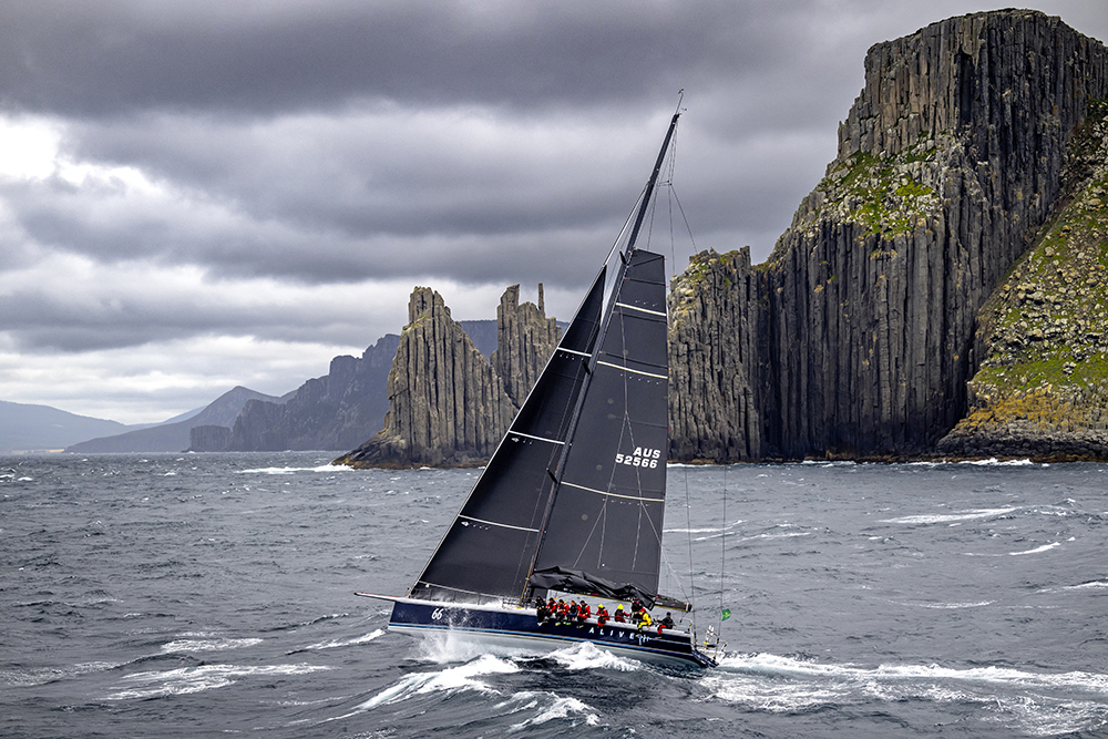 ALIVE, OVERALL WINNER OF THE ROLEX SYDNEY HOBART YACHT RACE 2023, ROUNDING TASMANIA'S ICONIC CAPE RAOUL